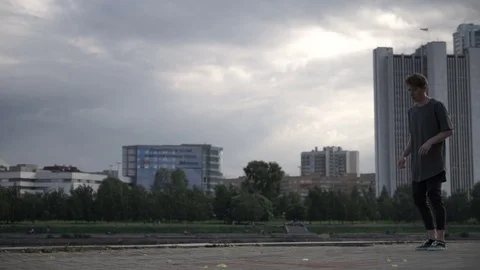 The guy does dance tricks on the street Stock Footage 81139747