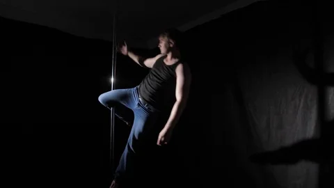 The guy does the exercise on the pole. Back light Stock Footage 76031549