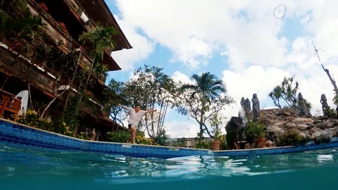 A guy does a front backflip into a pool in Bali Stock Footage 126142861