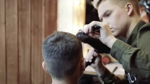 The guy does hair styling after haircuts. Barbershop. Video stock 95268652
