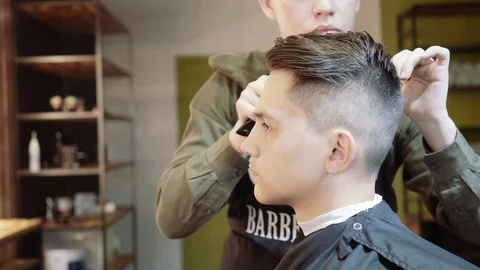 The guy does hair styling after haircuts. Barbershop. Stock Footage 95278147