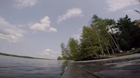 Guy does a neat flip into water off dock Stock Footage 52428071