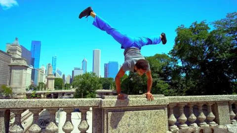 The guy does the trick on the concrete railing. Stock Photos