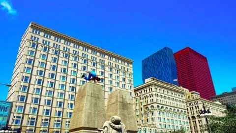 The guy does tricks on a concrete column in the city center. Stock Photos
