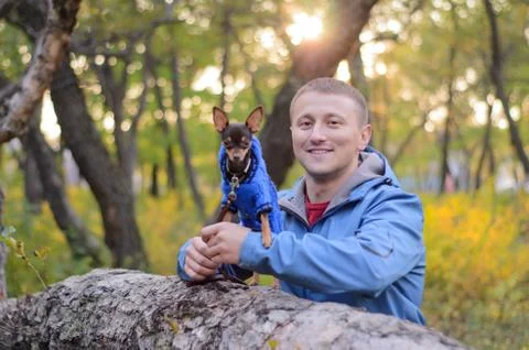 The guy with the dog in the park Stock Photos