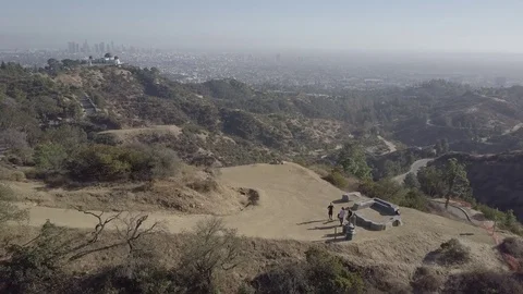 Guy with dog running up a hill with LA city view in the background 動画素材 82245537