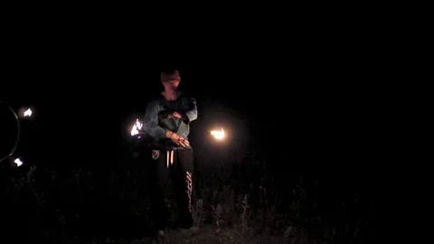 A guy doing a fire show at night in the dark. Stock Footage 81615515