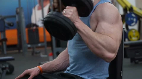Guy doing lifting dumbbells for biceps Stock Footage 62488611
