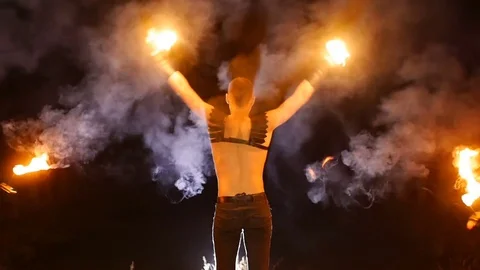 The guy doing a somersault. in the hands of fire. Close-up. Slow motion. flip Stock Footage 71530175