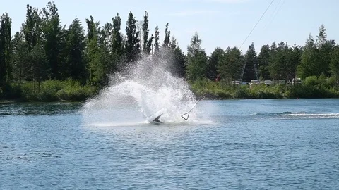Guy doing tricks with Cable wake boarding! Video stock 99466506