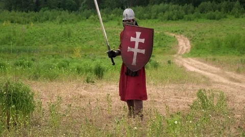 A guy dressed in a knight costume waves a sword Stock Footage 250002466
