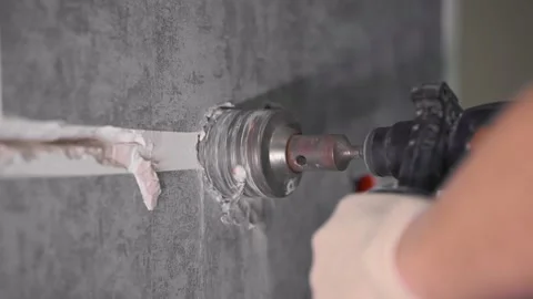 The guy is drilling the wall with a diamond bit Video stock 147077400