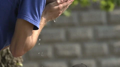 Guy drinking from public water in slow motion at summer on holiday Stock Footage 54915277