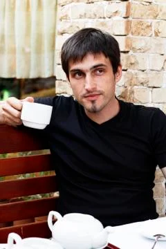 Guy is drinking tea in a cafe Stock Photos