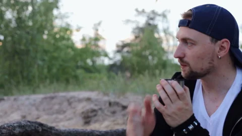 A guy drinks tea in the woods Stock Footage 92662037