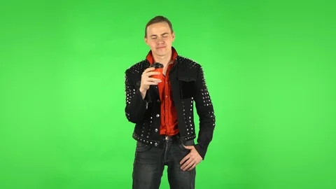 Guy drinks unpalatable coffee and is disgusted on green screen Stock Footage 125573745