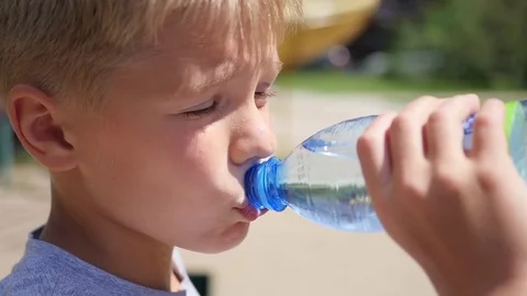 Guy drinks water from bottle outdoors Video stock 77102970