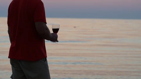 Guy Drinks Wine With A Glass On The Beach Stock Footage 96583492