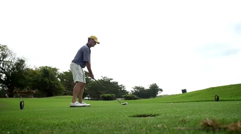 Guy drives golfball in slow motion Stock Footage 49836850