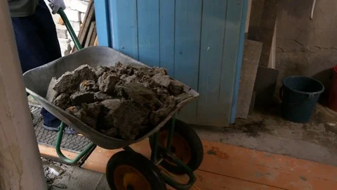 Guy drives a wheelbarrow with garbage Video stock 80281145