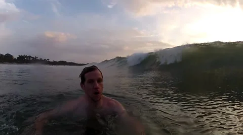 Guy ducks to avoid big wave Stock Footage 27691127