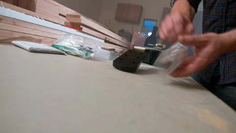 A guy dumping out a whole bunch of brand new tuning knobs getting ready to 動画素材 132266949