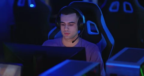 Guy of eastern appearance is playing an online game, a team online game. Guy Stock Footage 126019240