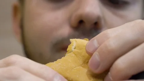 Guy eating a chicken burger Stock Footage 114753836