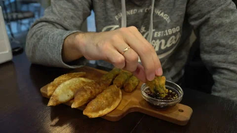 Guy Eating Korean Snacks At Cafe Stock Footage 123903661