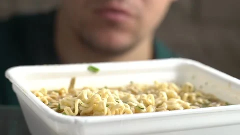 The guy eating noodles Stock Footage 131771564