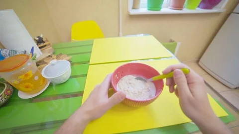 The guy eats breakfast oatmeal with milk, point of view Stock Footage 129552759