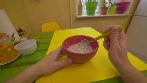 The guy eats breakfast oatmeal with milk, point of view Stock Footage 129553314