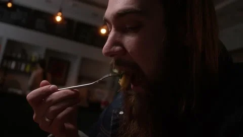 The guy eats in a cafe Stock Footage 223884080