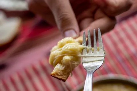 Guy eats with fork traditional turkish food with butter and cheese for breakf Stock Photos