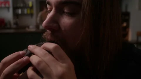 Guy eats a hamburger Stock Footage 223883002