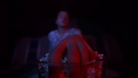 The guy eats popcorn and watches TV.Focus on popcorn Stock Footage 126093238