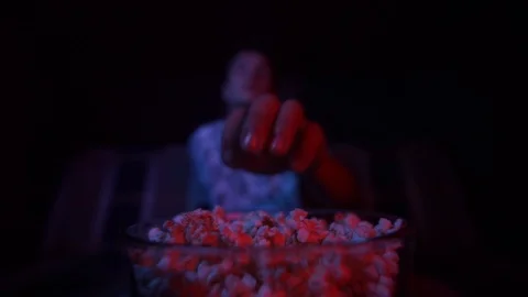 The guy eats popcorn and watches TV.Slow motion Stock Footage 126093259