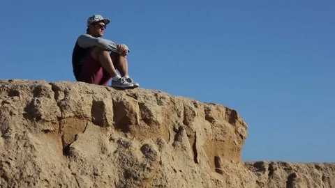 The guy on the edge of the cliff, down the sands Stock Footage 82453941