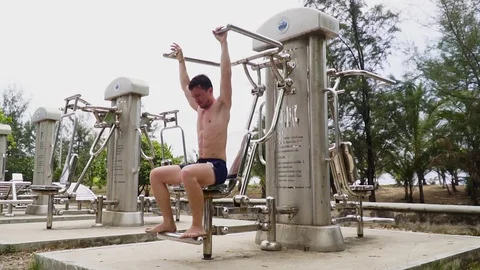 The guy is engaged in street exercise equipment Video stock 120050092