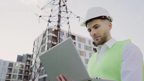Guy Engineer Standing Outdoors in Safety Clothes Inspects Power Line Using Stock Footage 251851924