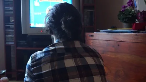 Guy is enjoying watch TV on a CTR screen Stock Footage 100321555