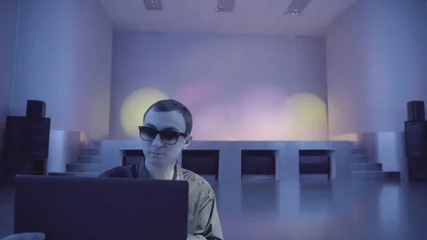 Guy enjoys a laptop being alone on the dance floor Stock Footage 71472876