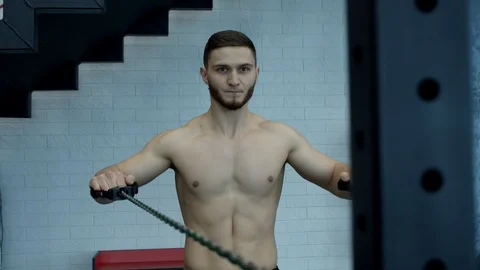 Guy execrcing in a gym with rubber Stock Footage 125843435
