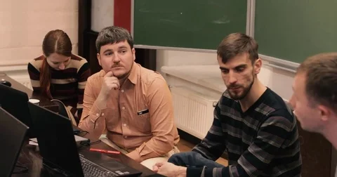 Guy explains something to the developers laptops Stock Footage 82222207