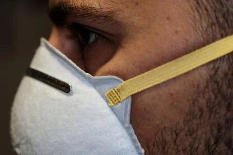 Guy face details while dressing corona virus covid-19 protective mask,disease Stock Photos