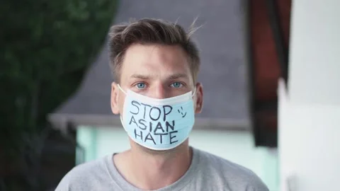 Guy with a face mask that says "Stop Asian Hate" Stock Footage 153752584