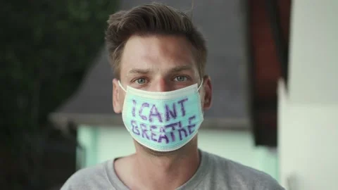Guy in a face shield that says "I can't breathe" Stock Footage 153745316