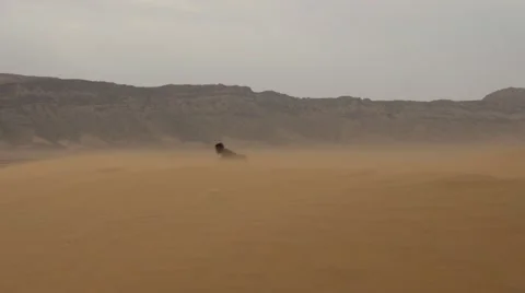 Guy falls on a desert sand Stock Footage 67558394