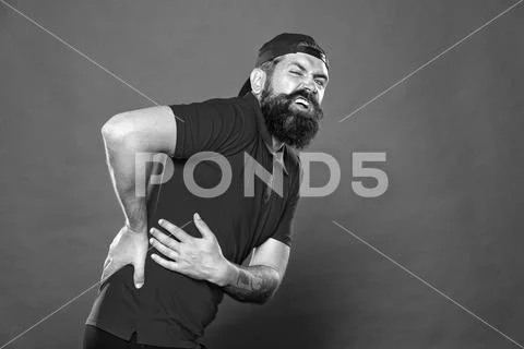 Guy feel pain in back. Healthcare and injuries concept. Sedentary lifestyle Stock Photos