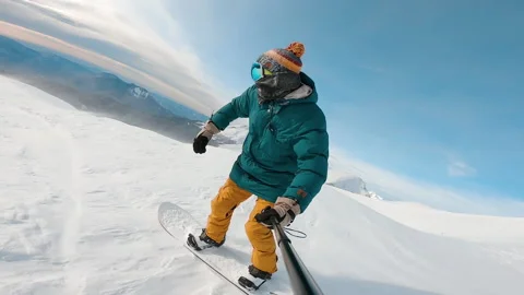 Guy filming himself during riding down. Man riding on snowboard with selfie Video stock 148300572